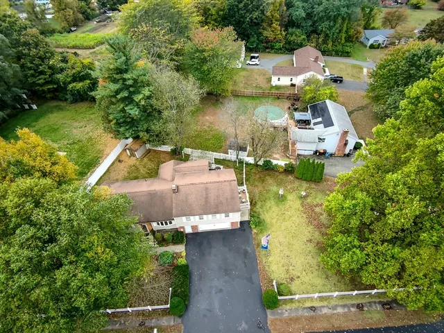 an aerial view of a house with a garden and lake view