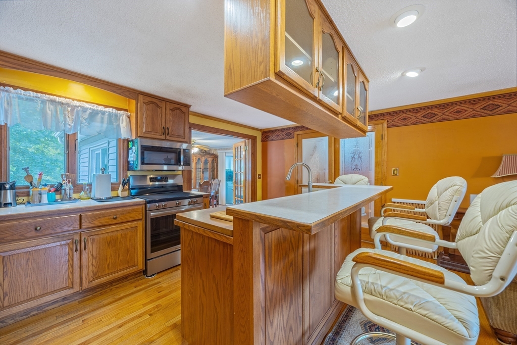 60 Elizabeth Street Feeding Hills, MA 01030 - Photo 5 of 39 a kitchen that has a lot of cabinets in it and wooden floors
