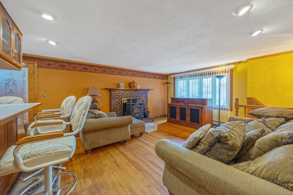 60 Elizabeth Street Feeding Hills, MA 01030 - Photo 6 of 39 a living room with furniture two large window and a wooden floor