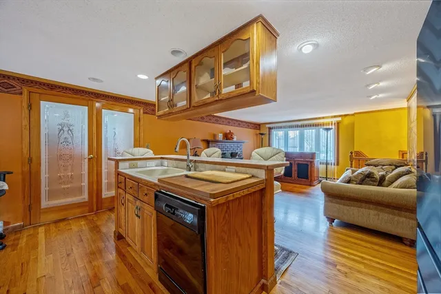 a kitchen with stainless steel appliances granite countertop a stove and a wooden floors