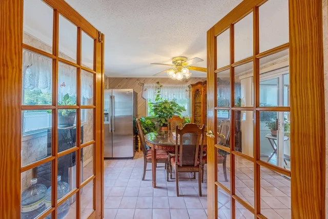 a dining room with furniture and floor to ceiling windows