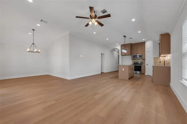 a view of a kitchen with a sink and a refrigerator