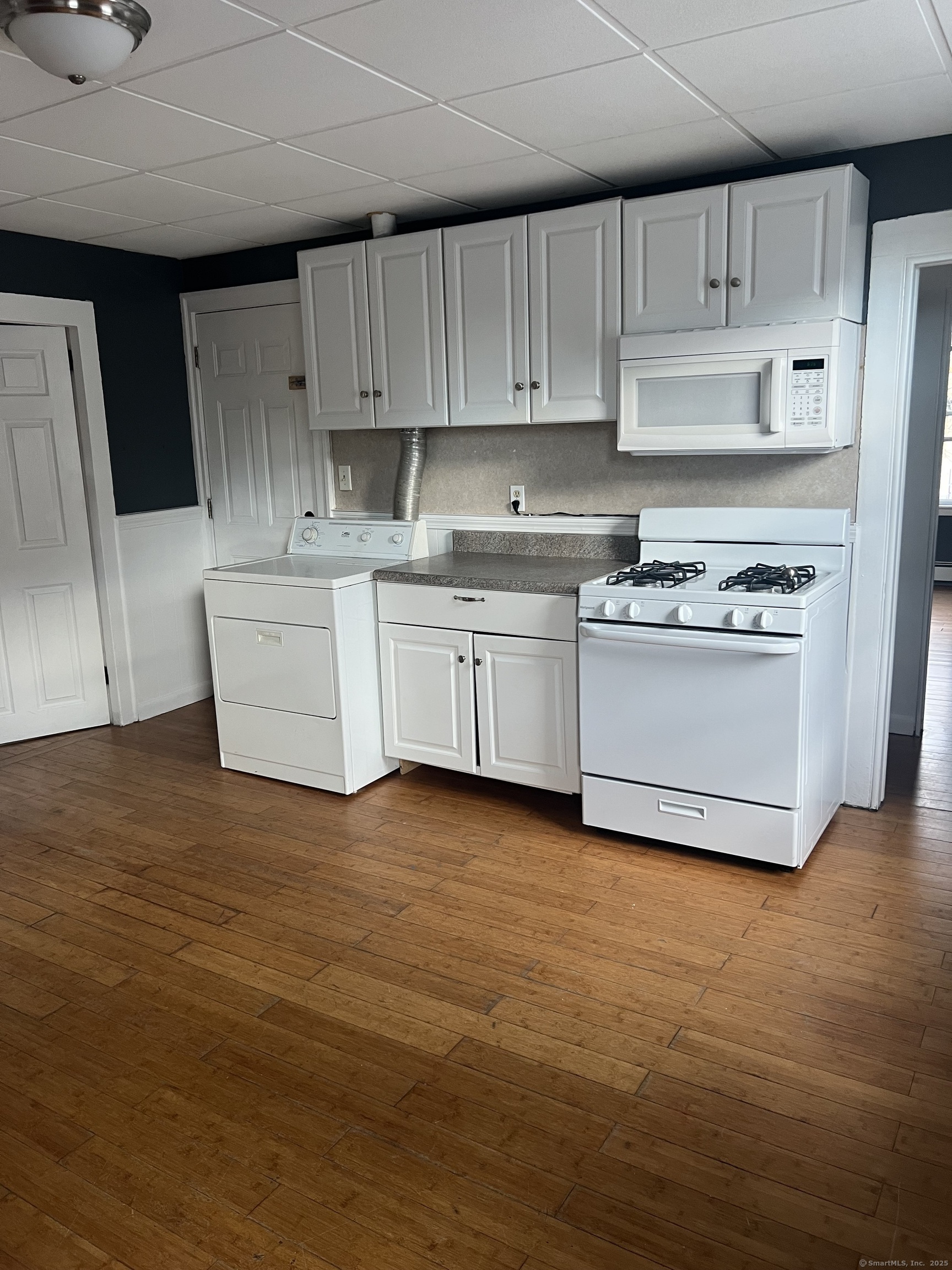52 Spring Street Middletown, CT 06457 - Photo 1 of 6 a kitchen with granite countertop a sink a stove a refrigerator and white cabinets