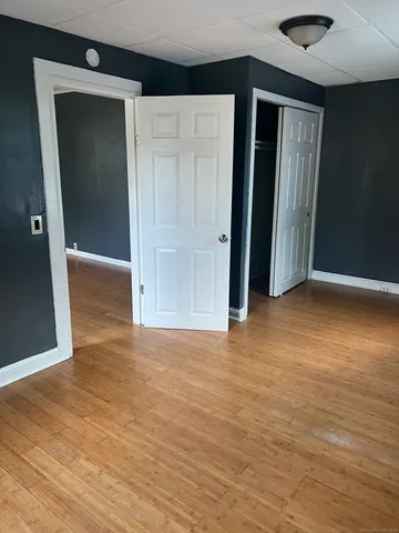 a view of hallway with wooden floor