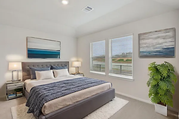 a bedroom with a bed potted plant and a window