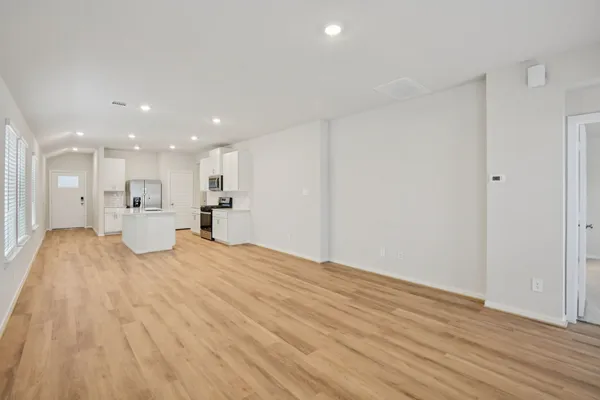 a view of a kitchen with a sink and wooden floor