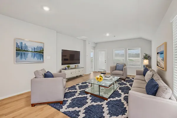a living room with furniture and a flat screen tv