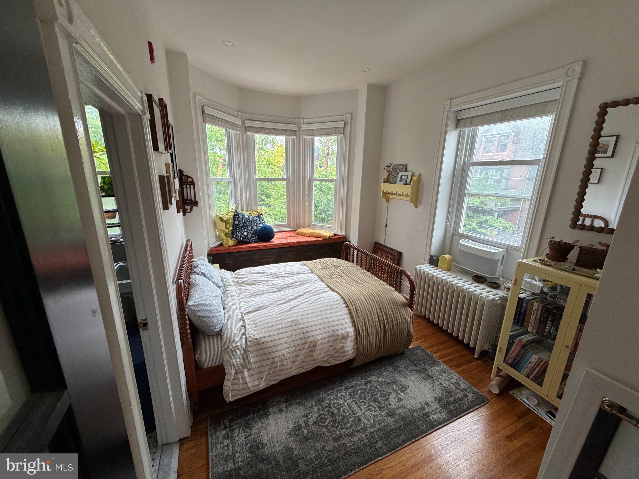 815 South 49th Street Philadelphia, PA 19143 - Photo 29 of 72 a bedroom with a bed wooden floor and a large window