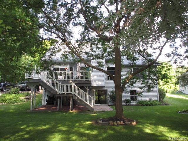 11356 Tall Shadows Court Pinckney, MI 48169 - Photo 5 of 29 Expansive rear yard with a multi-level deck and ground-level patio