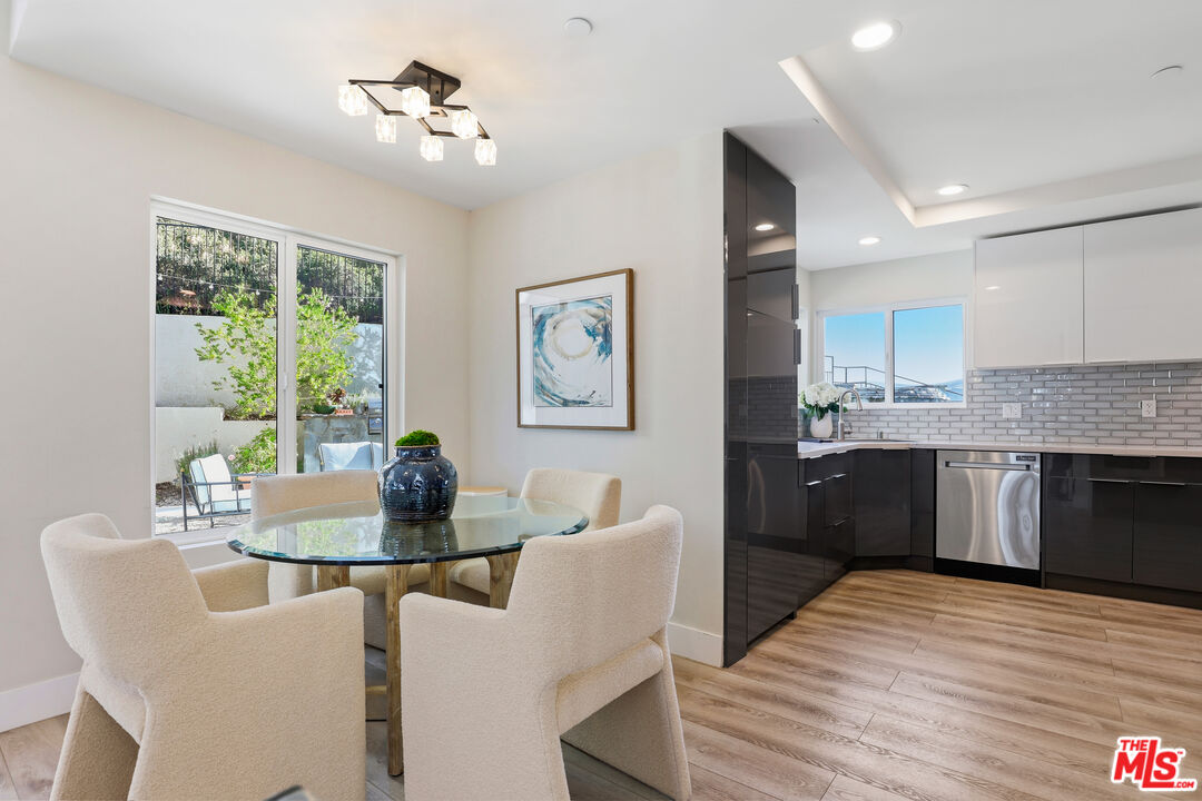 53 Saddlebow Road Bell Canyon, CA 91307 - Photo 18 of 66 a kitchen with stainless steel appliances granite countertop a stove a refrigerator a dining table and chairs with wooden floor