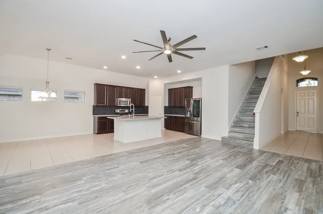 a view of kitchen with microwave and refrigerator