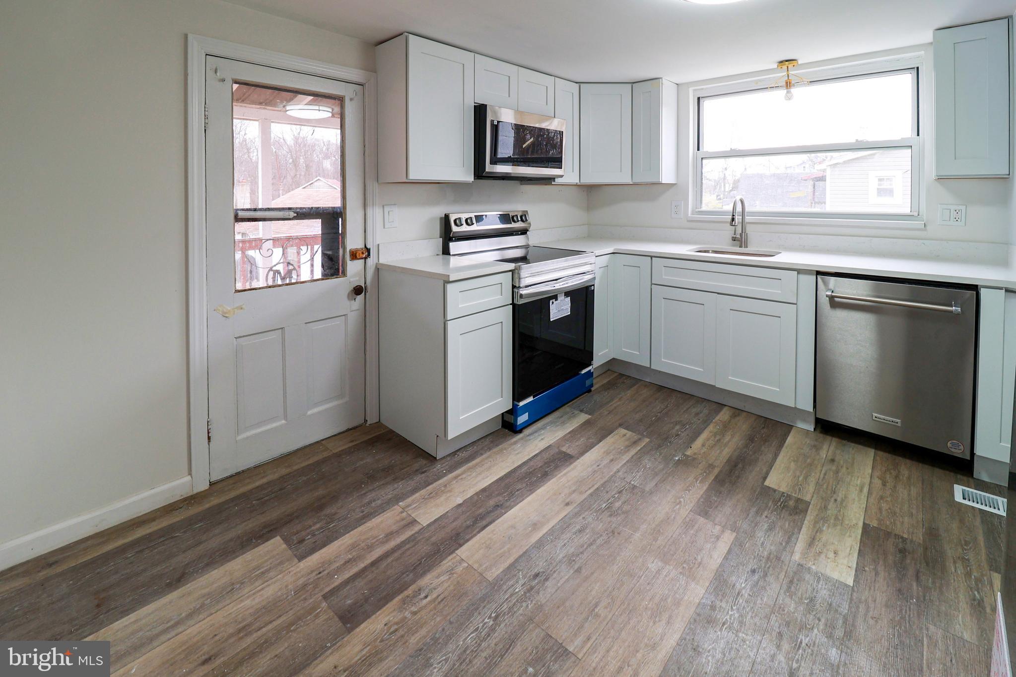 495 York Haven Road York Haven, PA 17370 - Photo 14 of 58 a kitchen with a sink cabinets stainless steel appliances and a window