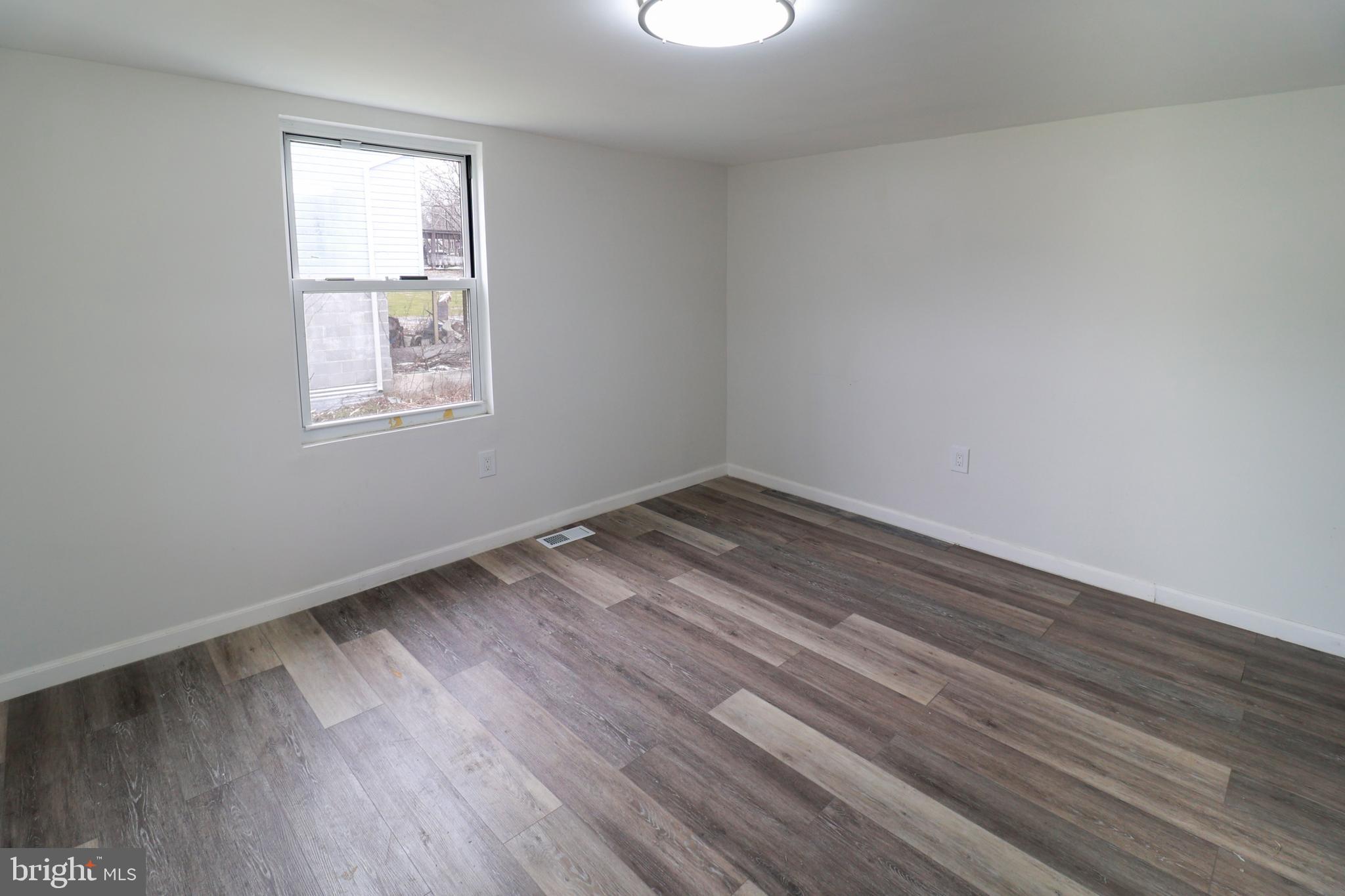 495 York Haven Road York Haven, PA 17370 - Photo 18 of 58 an empty room with wooden floor and windows