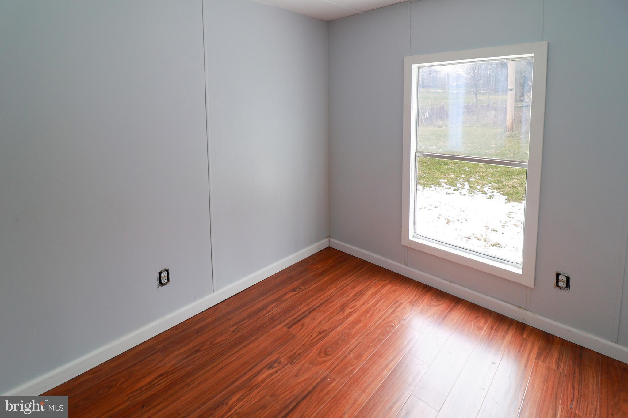 495 York Haven Road York Haven, PA 17370 - Photo 49 of 58 a view of an empty room with wooden floor and a window