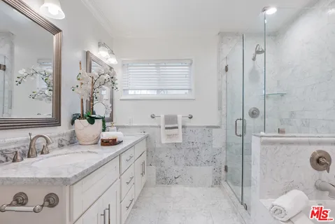 a bathroom with double sink and a mirror