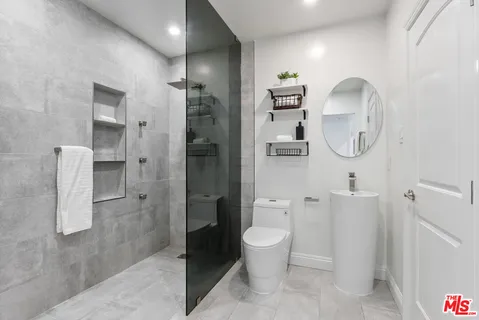 a bathroom with a toilet sink and shower