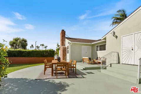 a view of a patio with a table and chairs