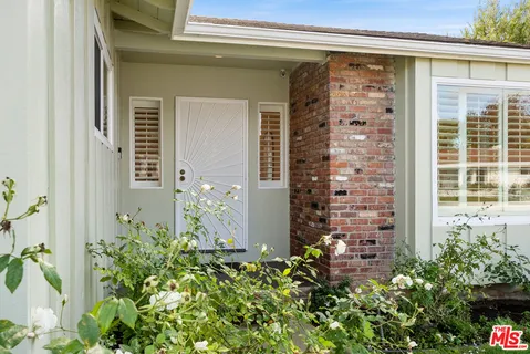 front view of a door with a potted plant