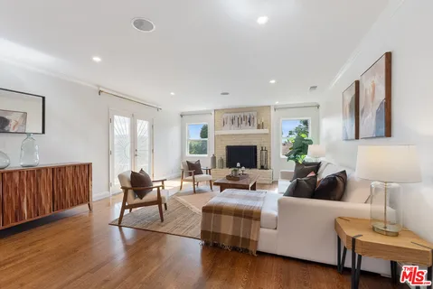 a living room with furniture a fireplace and a table