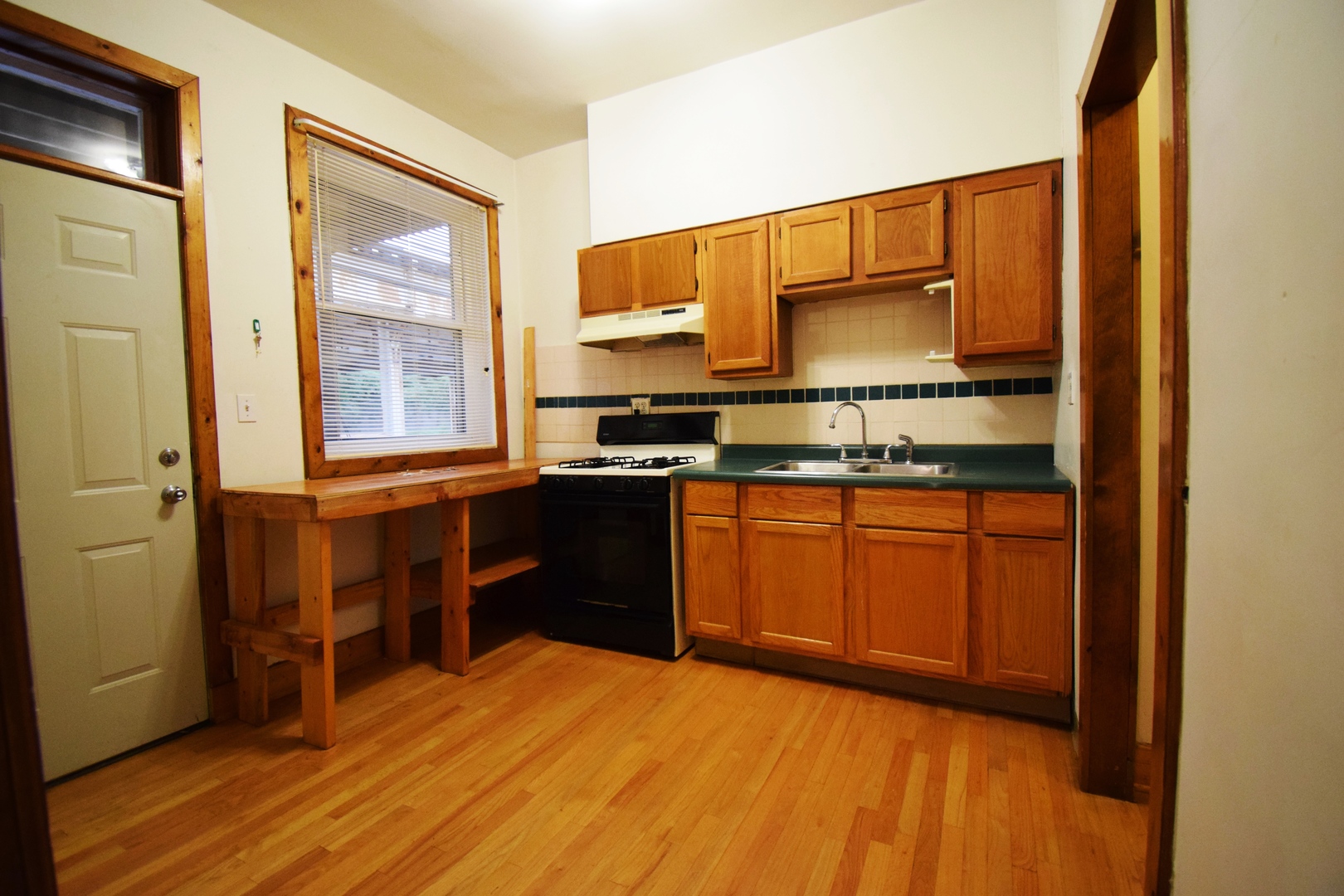 4326 North Kenmore Avenue, Unit 1 Chicago, IL 60613 - Photo 11 of 14 a kitchen with stainless steel appliances granite countertop a stove a sink and a refrigerator