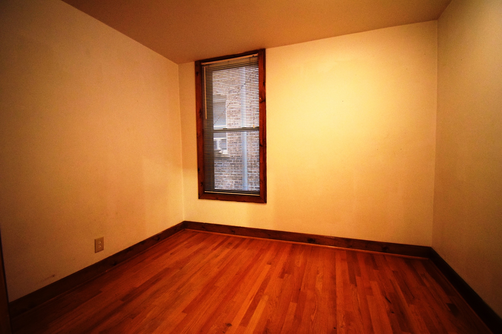 4326 North Kenmore Avenue, Unit 1 Chicago, IL 60613 - Photo 13 of 14 a view of an empty room with wooden floor and a window