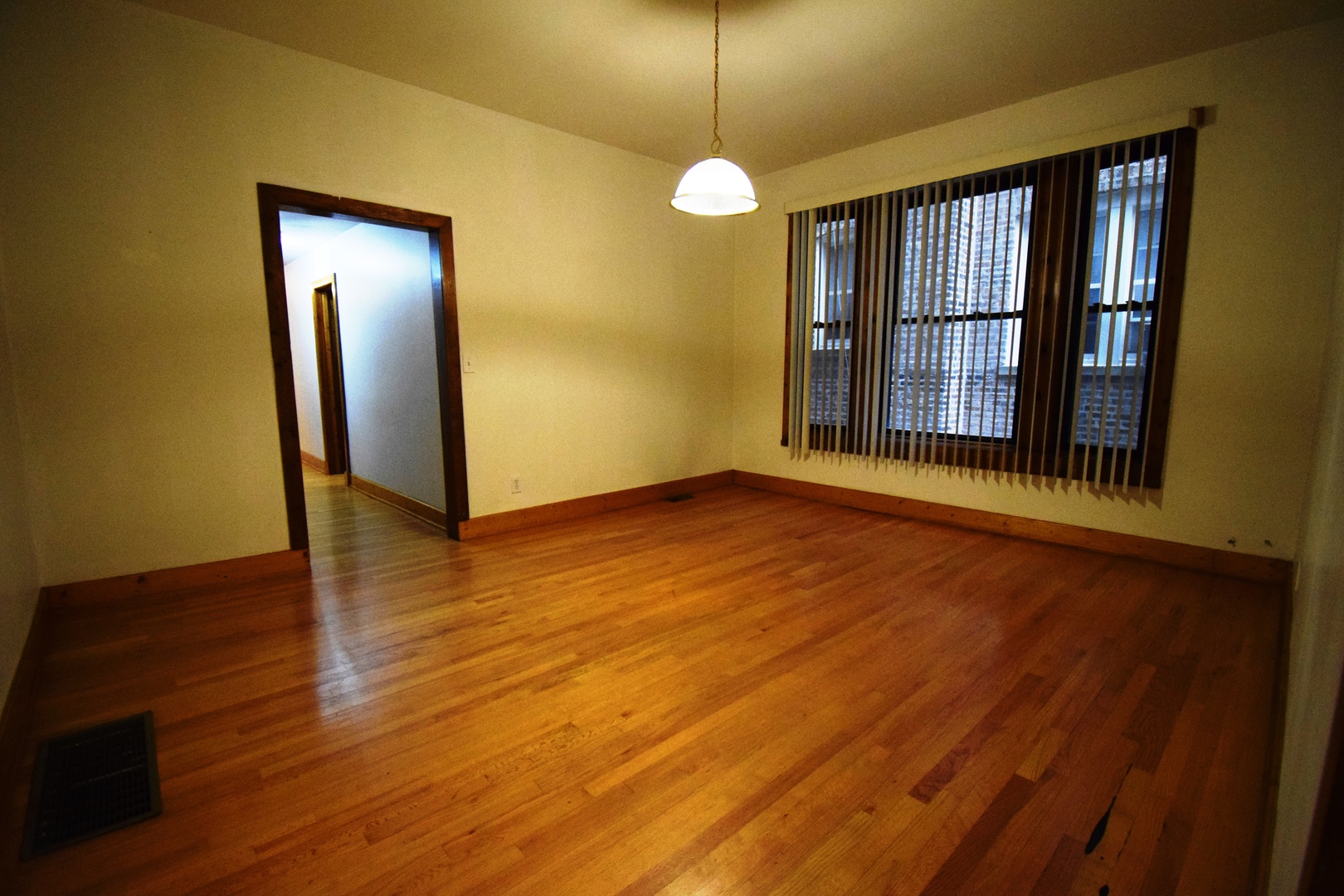 4326 North Kenmore Avenue, Unit 1 Chicago, IL 60613 - Photo 10 of 14 an empty room with wooden floor and windows
