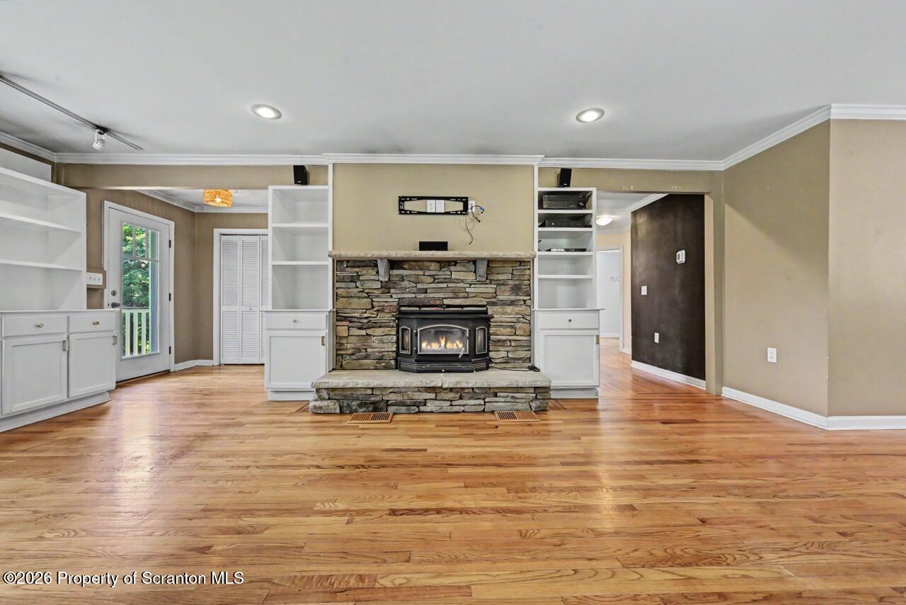 457 Craig Road Dalton, PA 18414 - Photo 18 of 114 a view of a livingroom with a fireplace a fireplace and windows