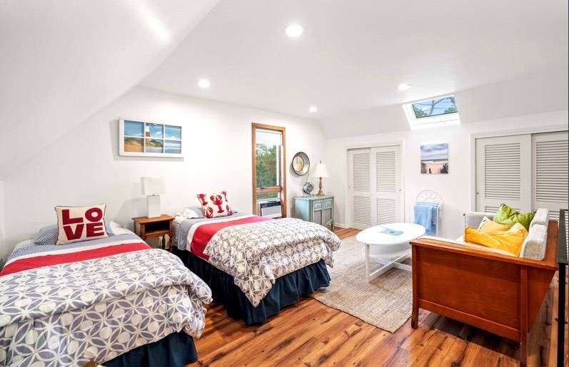 32 Surf Drive Amagansett, NY 11930 - Photo 6 of 14 a bedroom with two beds and a couch