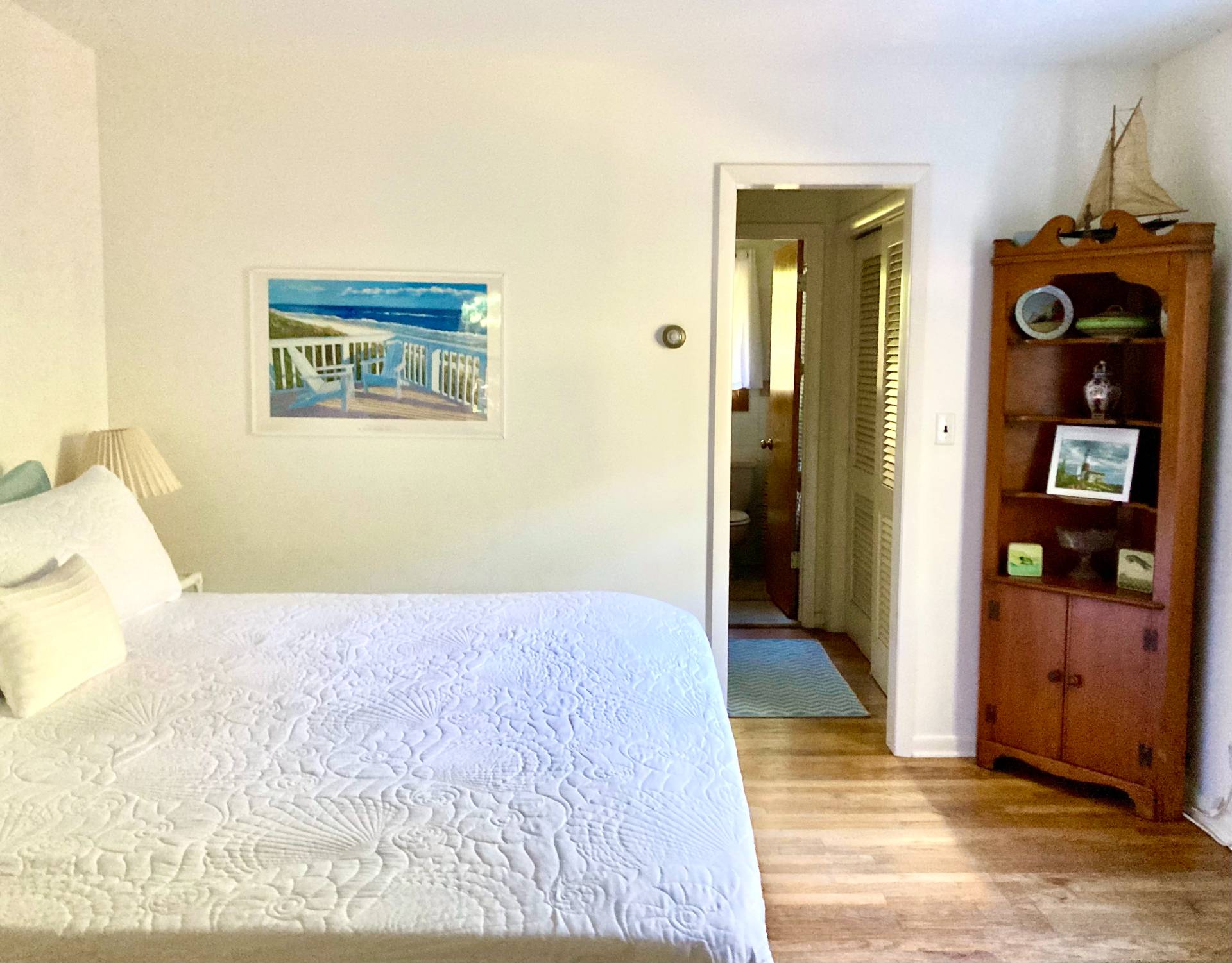 32 Surf Drive Amagansett, NY 11930 - Photo 8 of 14 a view of a hallway with wooden floor and closet