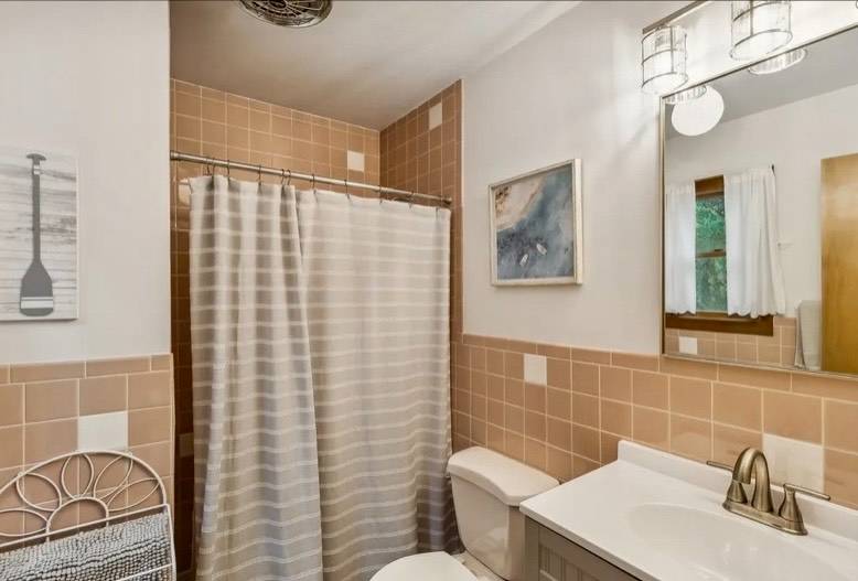 32 Surf Drive Amagansett, NY 11930 - Photo 10 of 14 a bathroom with a sink toilet and shower