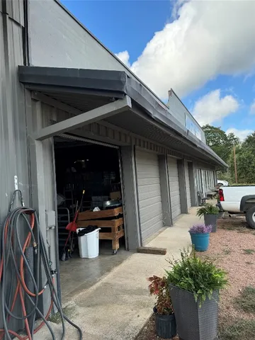 a view of a dry yard with wooden fence