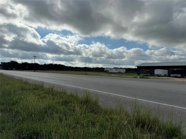 a sign board with a tree in the background