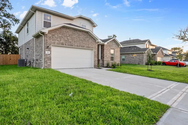 a front view of a house with a yard and garage