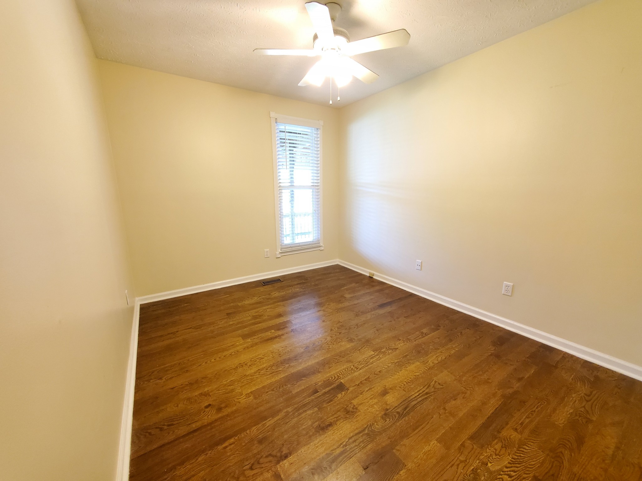 324 West Harper Road Portland, TN 37148 - Photo 14 of 25 an empty room with a window and a ceiling fan