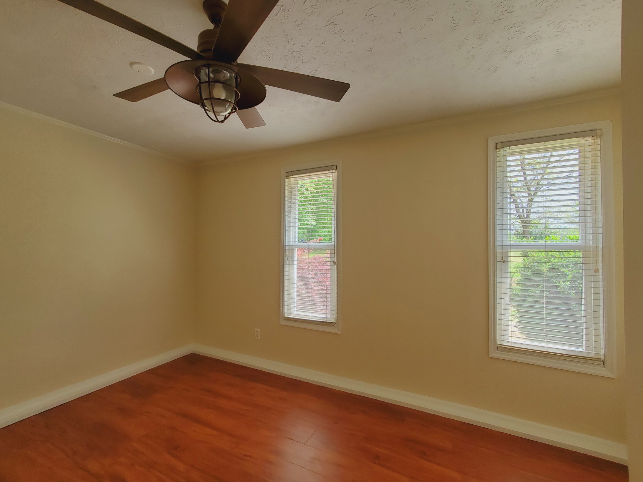 324 West Harper Road Portland, TN 37148 - Photo 18 of 25 a view of an empty room with wooden floor and a window