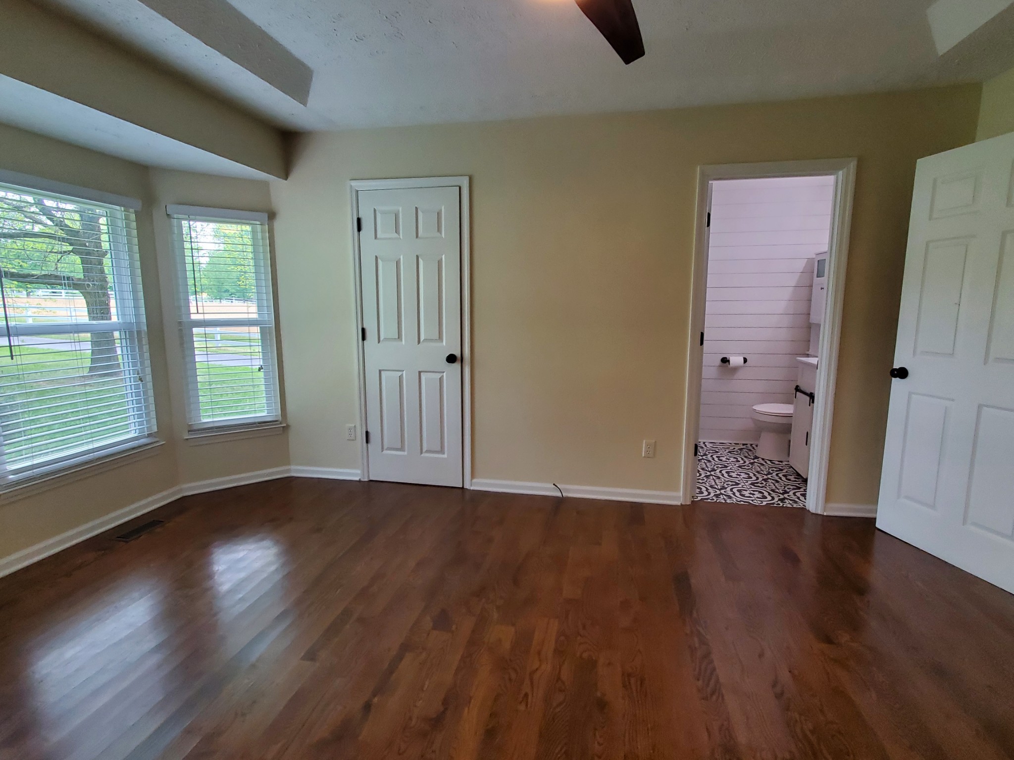 324 West Harper Road Portland, TN 37148 - Photo 10 of 25 a view of an empty room with wooden floor and a window