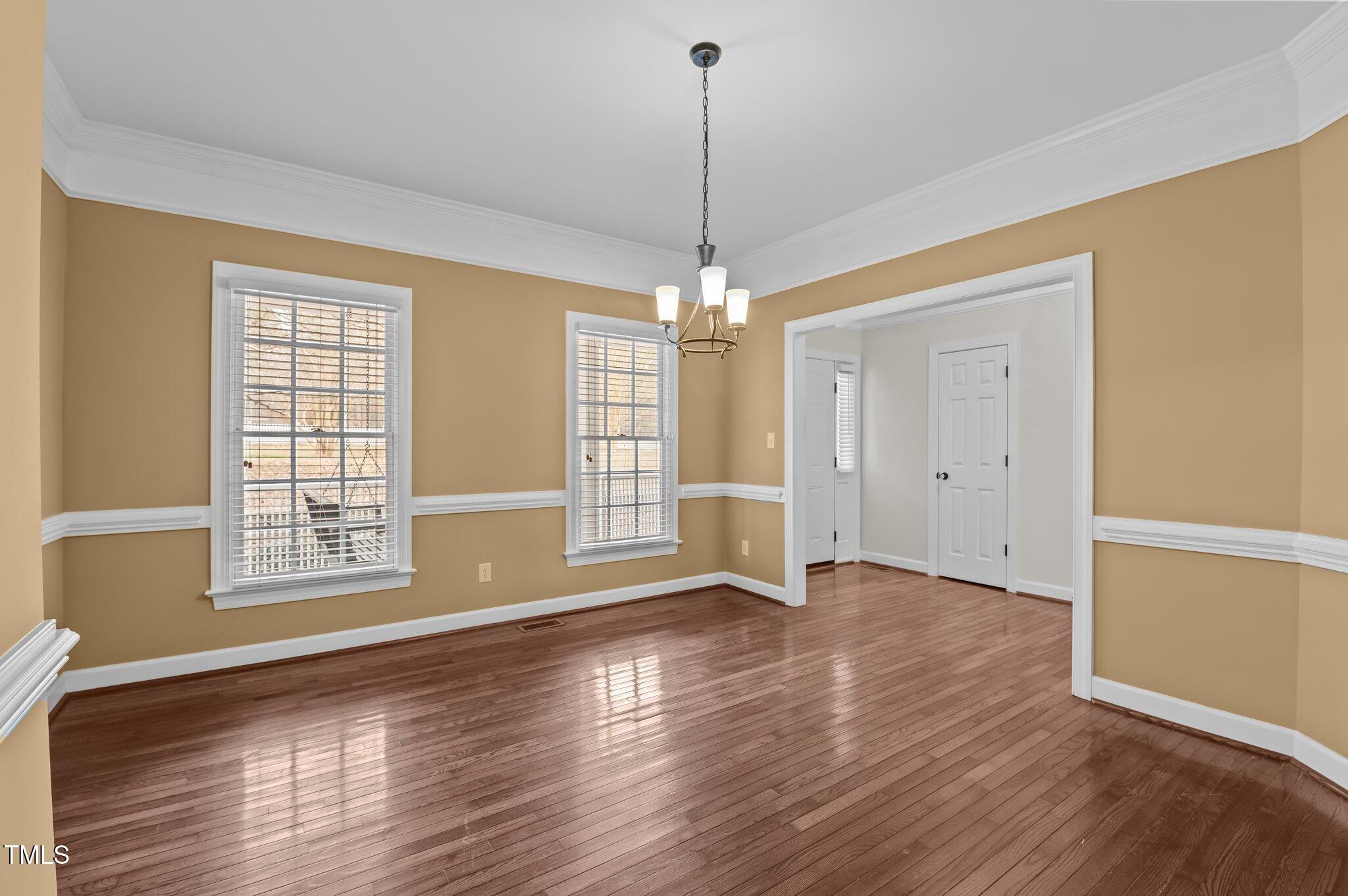 2517 Mt Vernon Church Road Raleigh, NC 27614 - Photo 11 of 45 a view of an empty room with wooden floor and a window