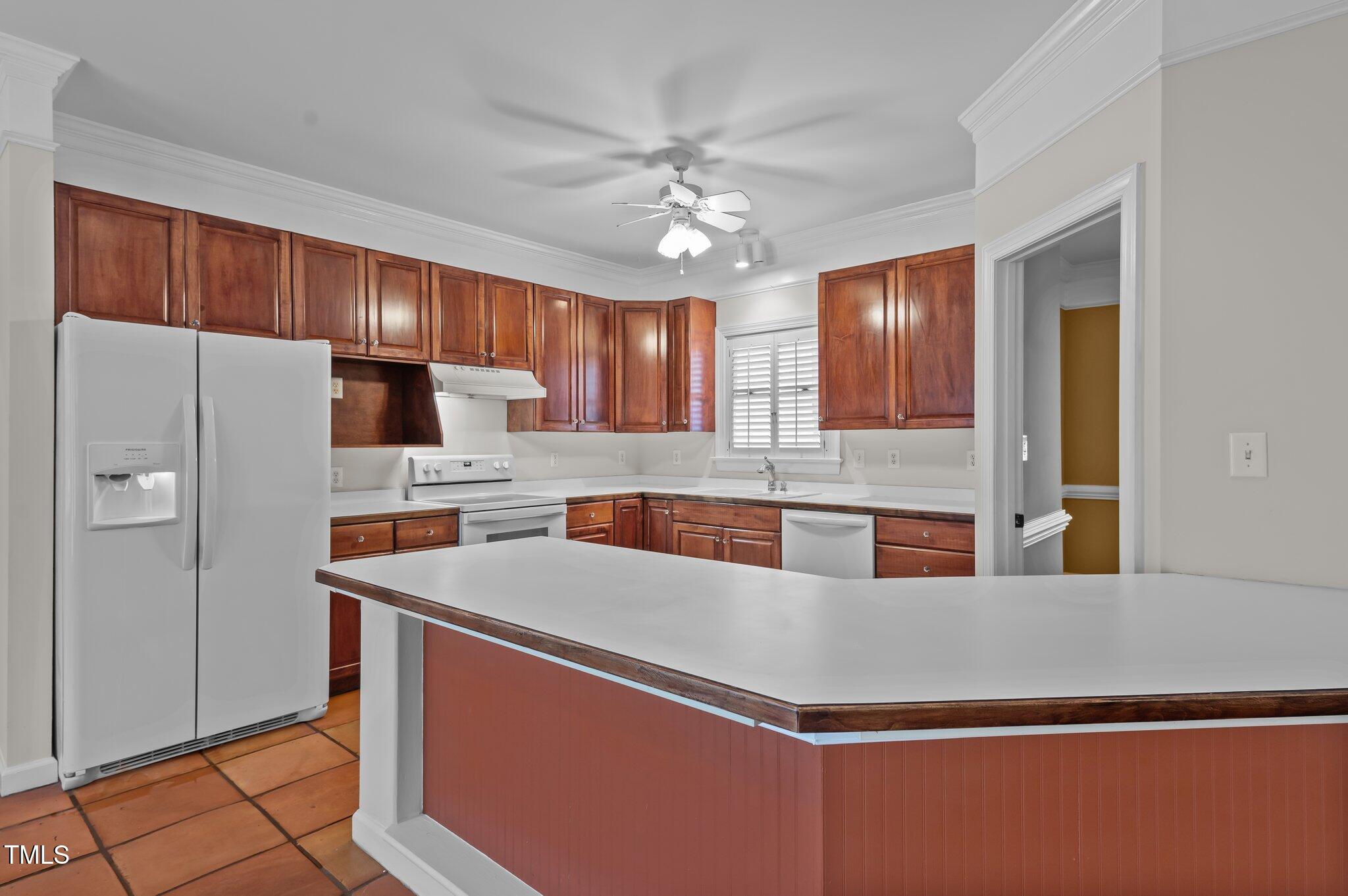 2517 Mt Vernon Church Road Raleigh, NC 27614 - Photo 15 of 45 a large kitchen with stainless steel appliances granite countertop a refrigerator a sink dishwasher a stove and white countertops with wooden floor