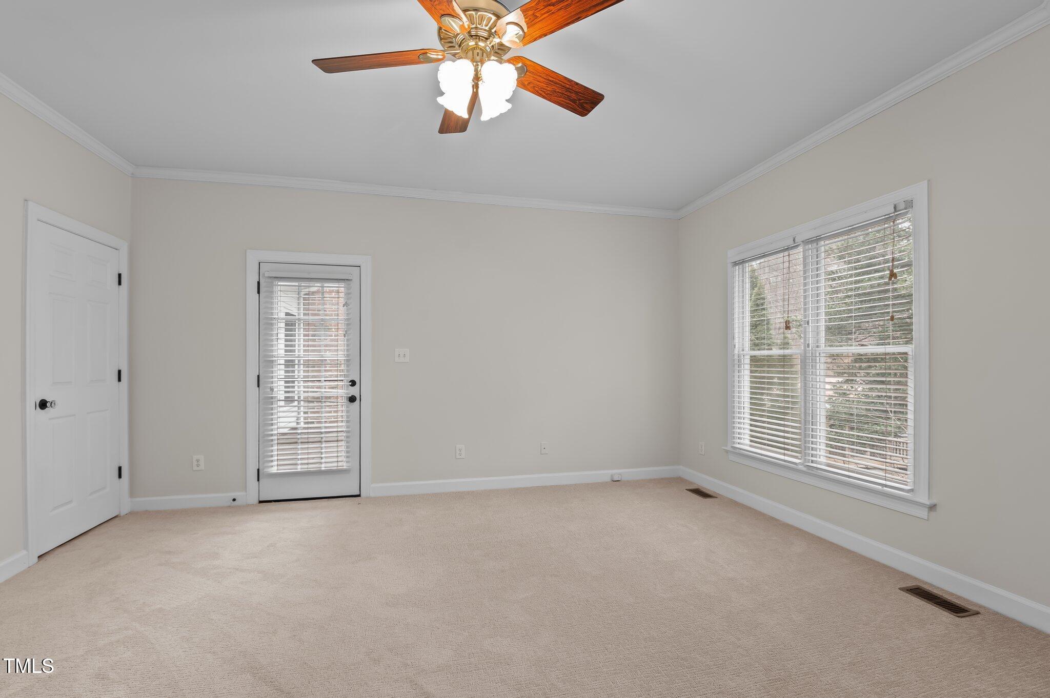 2517 Mt Vernon Church Road Raleigh, NC 27614 - Photo 21 of 45 an empty room with windows and chandelier fan