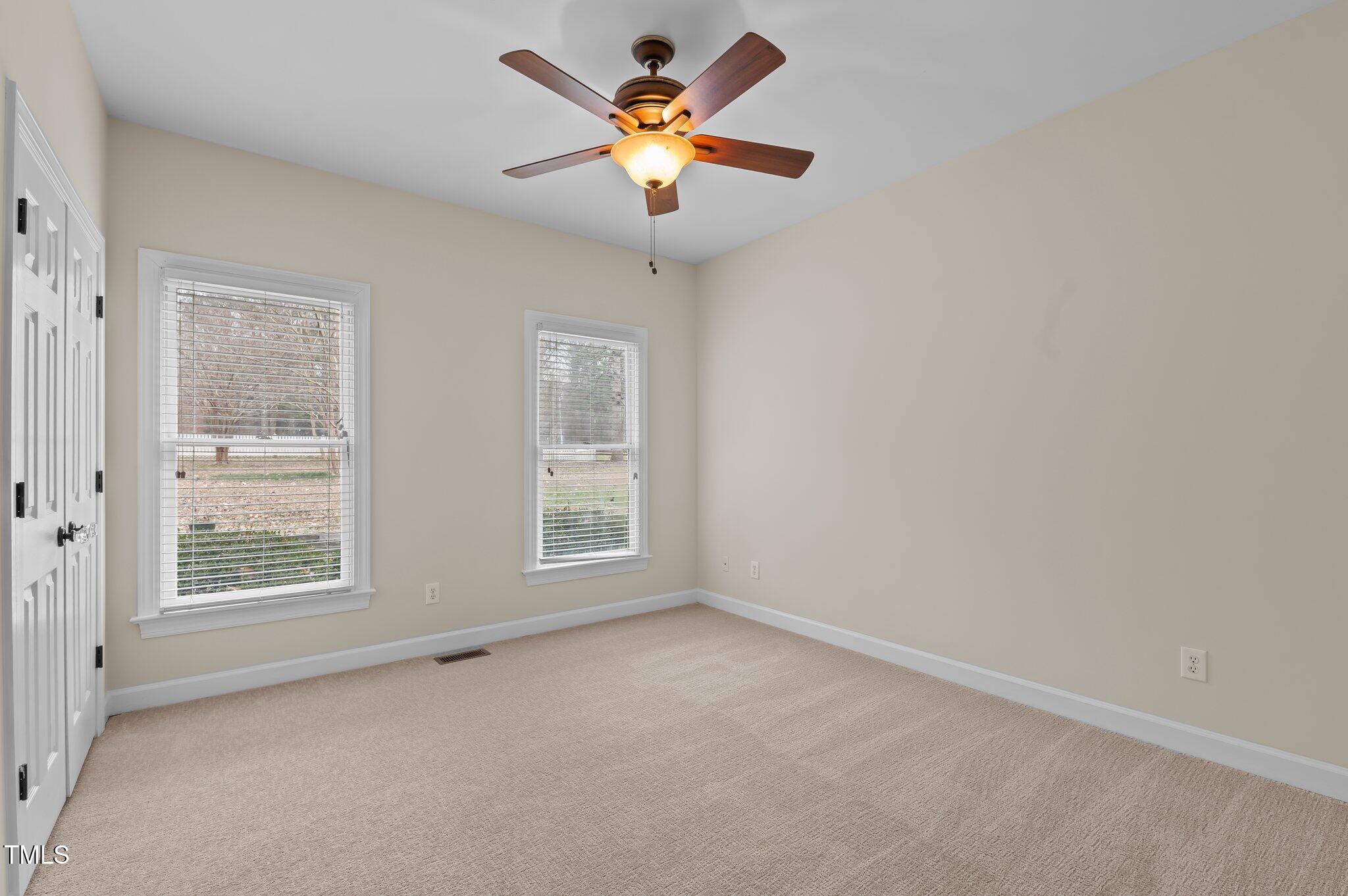 2517 Mt Vernon Church Road Raleigh, NC 27614 - Photo 28 of 45 an empty room with windows and chandelier fan