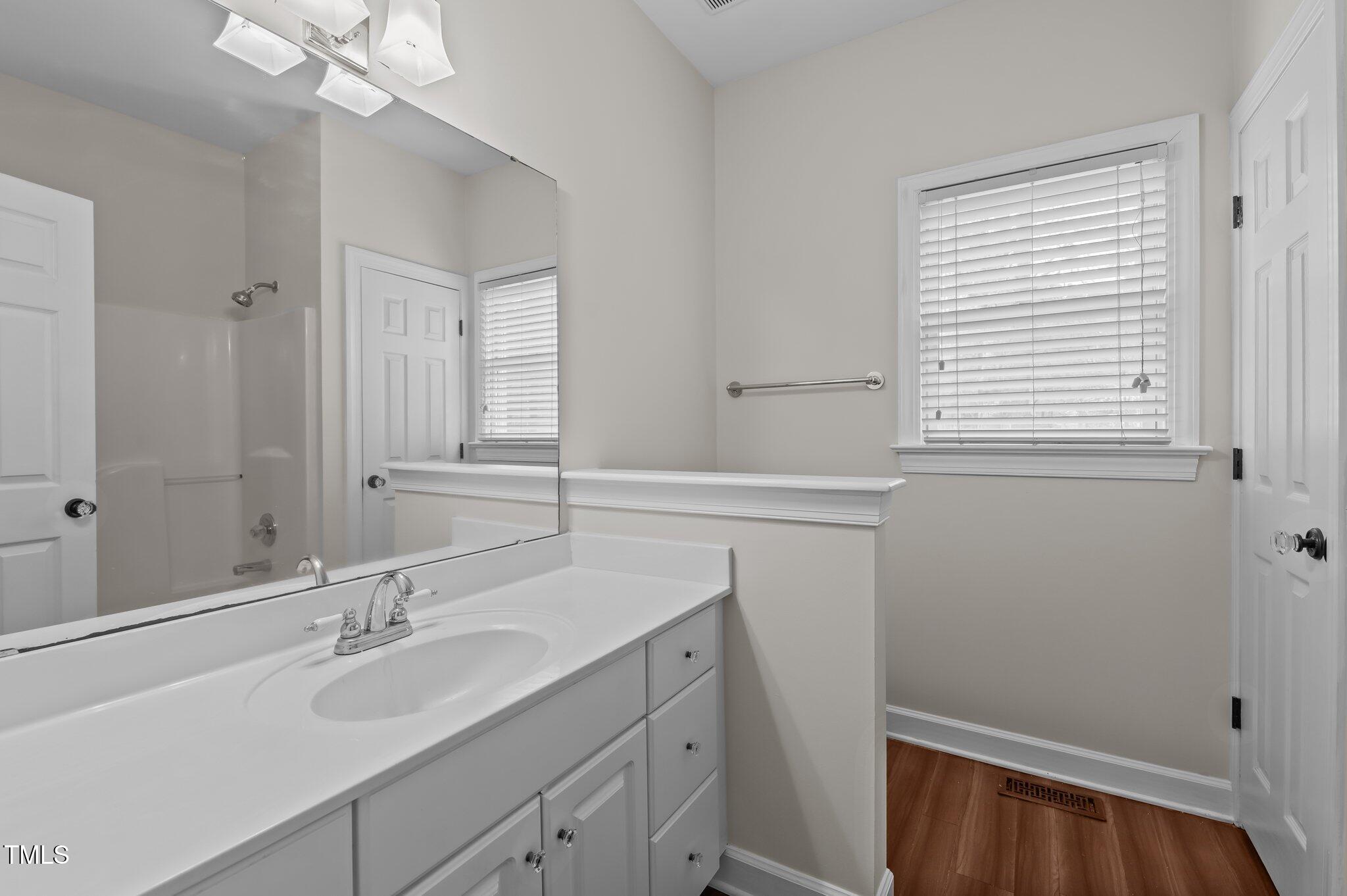 2517 Mt Vernon Church Road Raleigh, NC 27614 - Photo 32 of 45 a bathroom with a sink a vanity and a mirror