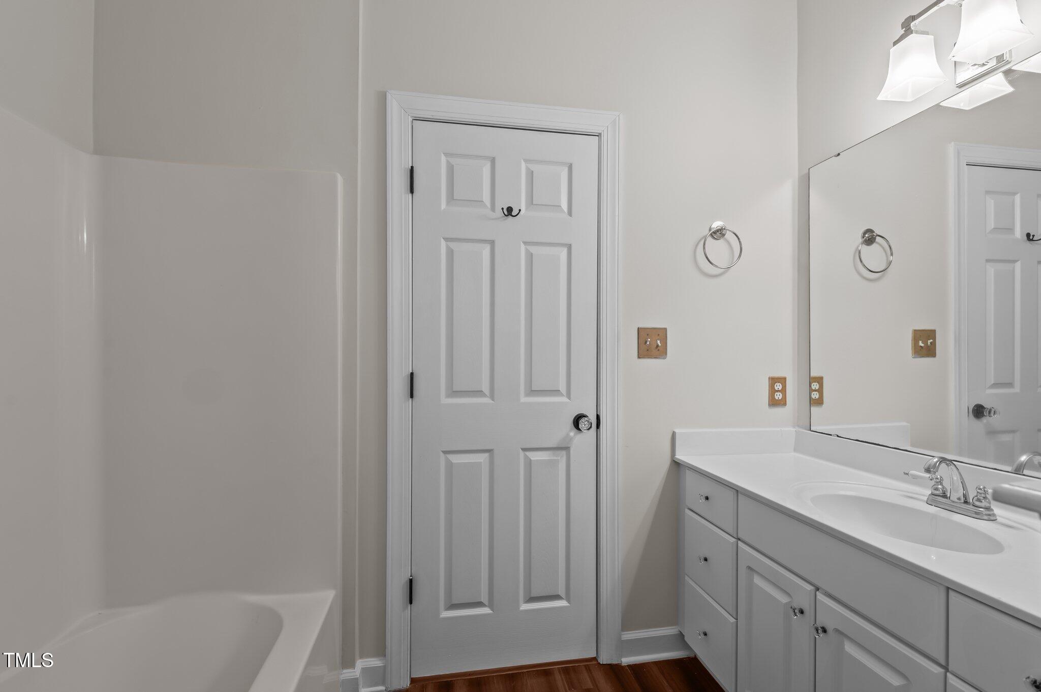 2517 Mt Vernon Church Road Raleigh, NC 27614 - Photo 33 of 45 a bathroom with a tub sink vanity and mirror