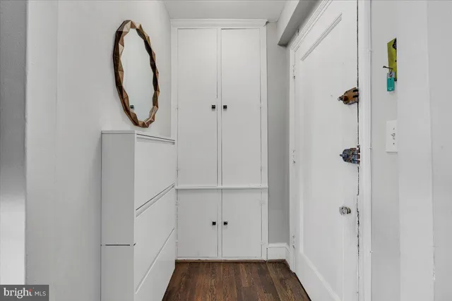 a view of a hallway with wooden floor