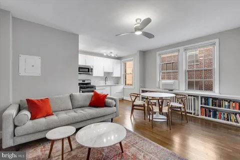 a living room with furniture fireplace and a window
