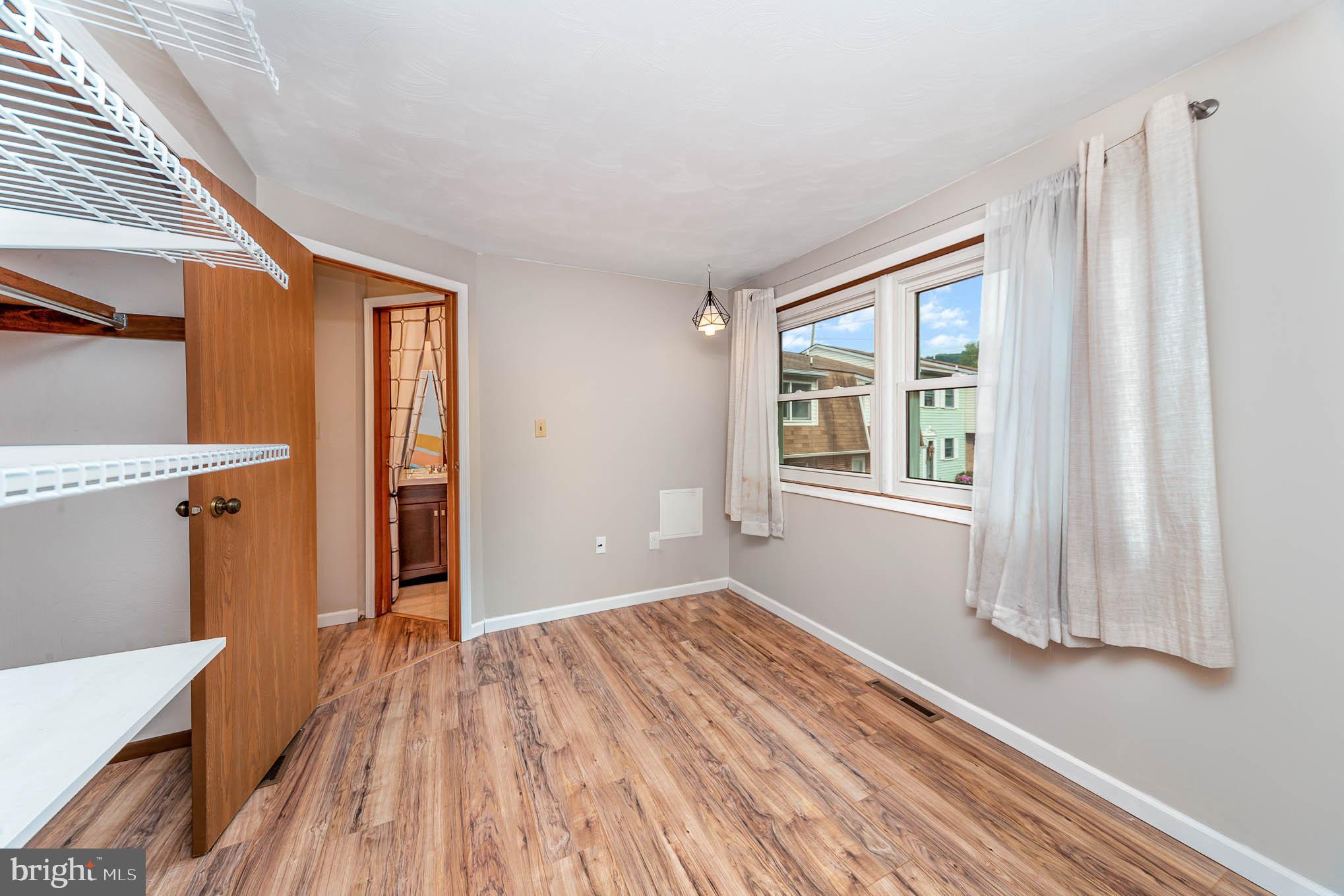 568 Valley Road Enola, PA 17025 - Photo 14 of 27 a view of empty room with wooden floor and fan