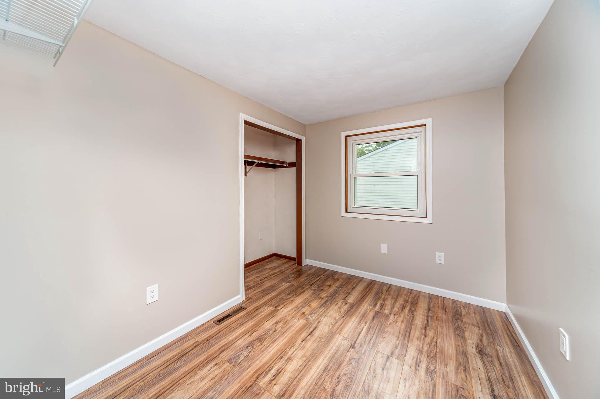 568 Valley Road Enola, PA 17025 - Photo 15 of 27 a view of an empty room with wooden floor and a window