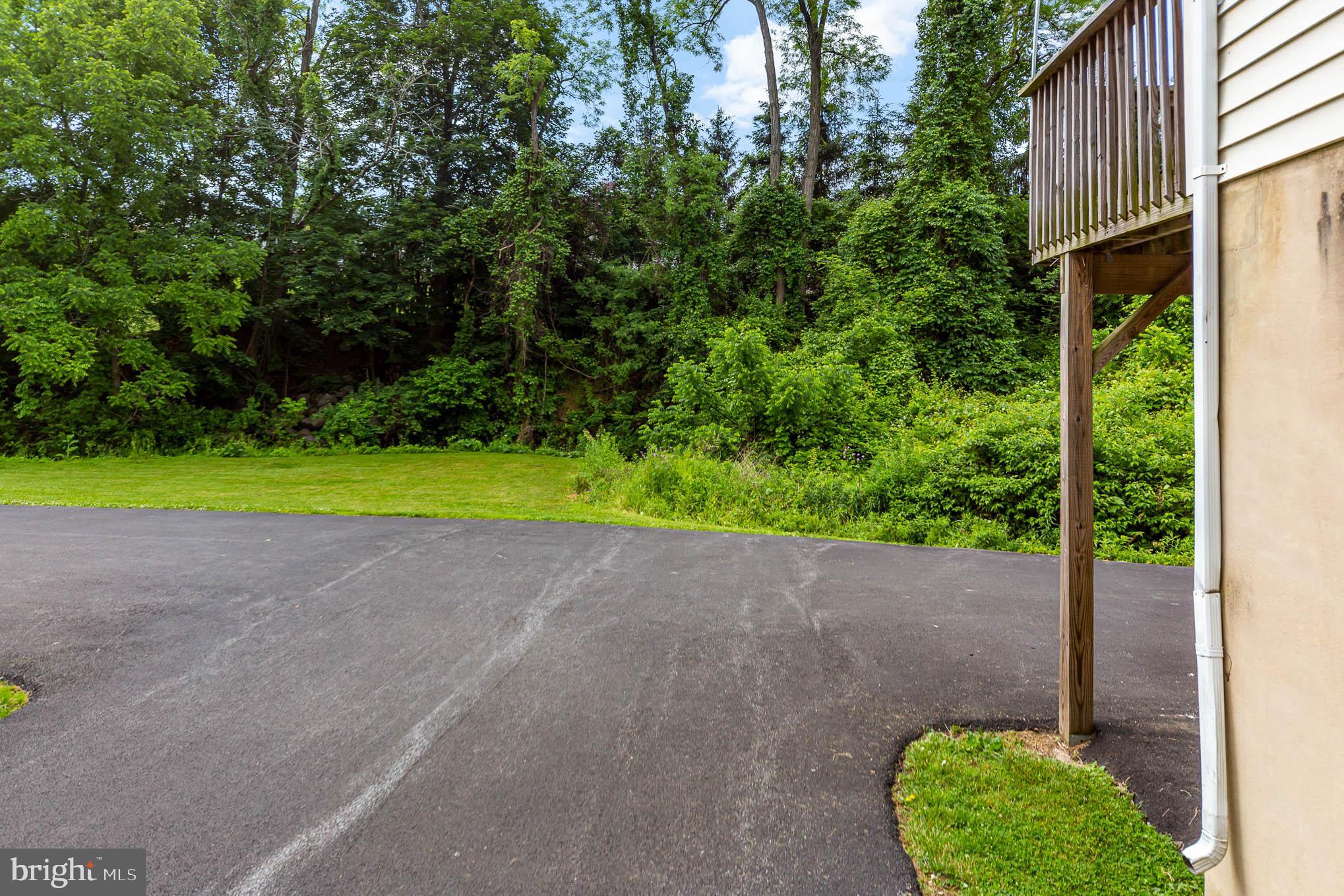 568 Valley Road Enola, PA 17025 - Photo 25 of 27 a view of a backyard with plants and palm tree