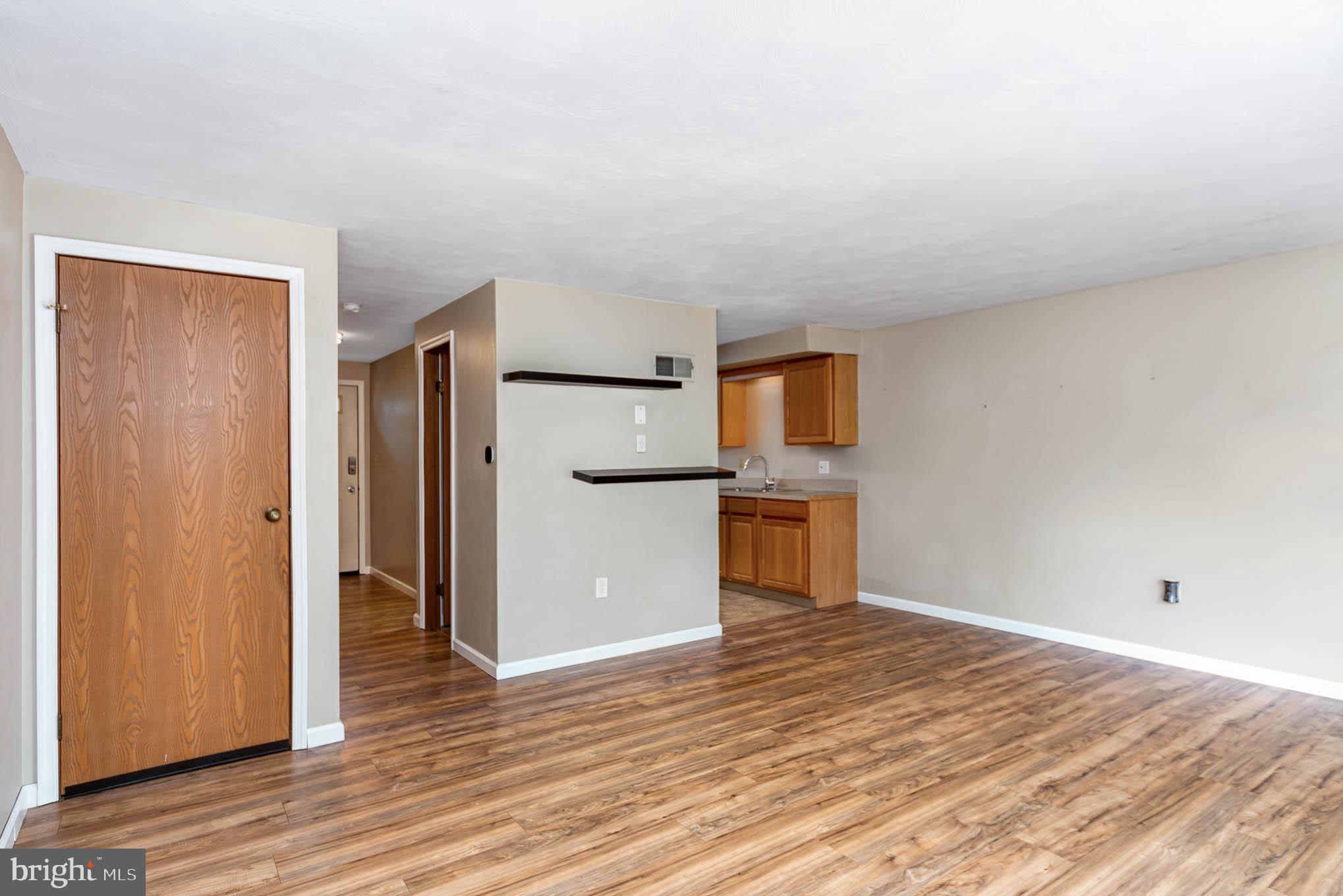 568 Valley Road Enola, PA 17025 - Photo 5 of 27 a view of a kitchen with refrigerator and wooden floor