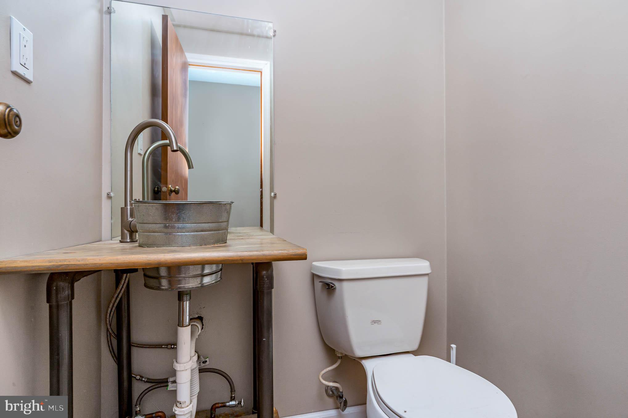 568 Valley Road Enola, PA 17025 - Photo 9 of 27 a bathroom with a toilet sink and mirror