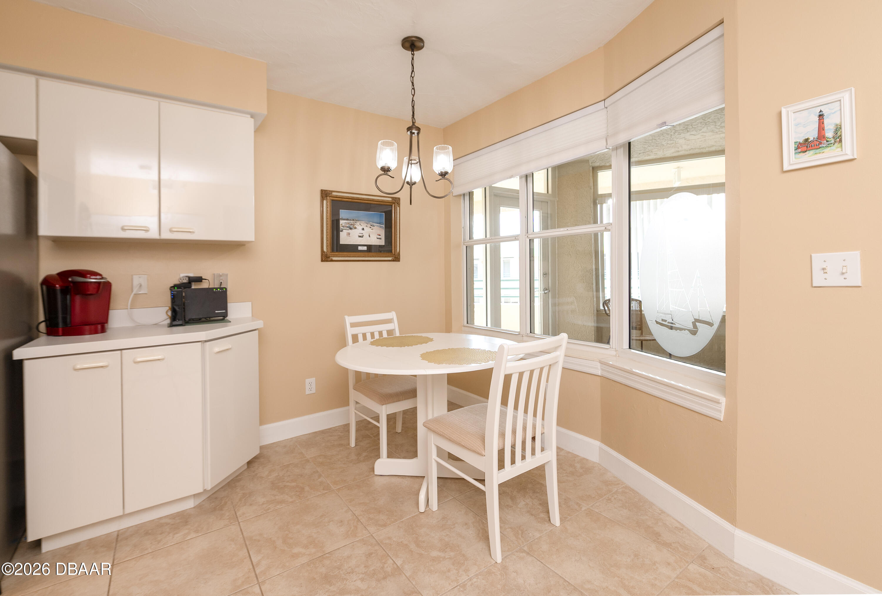 4575 South Atlantic Avenue, Unit 6701 Ponce Inlet, FL 32127 - Photo 14 of 35 a dining room with furniture a chandelier and window